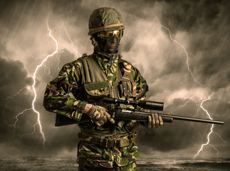 Armed soldier standing in rainy obscure weather