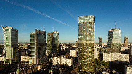 Aerial view of an urban metropolis with modern architecture and buildings at sunset. Warsaw. Poland. 19. September. 2019. Drone shot on cityscape business downtown.