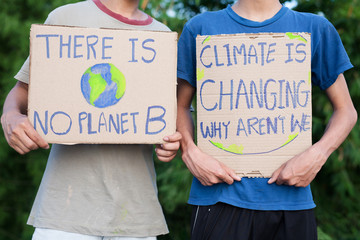 People of demonstration show a message on banner to against climate change, plastic pollution and...