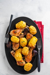 Oven-roasted spicy Chicken with Potatoes,Garlic, Onions, Lemon and Fresh Parsley. Symbolic image. Home made food. Concept for a tasty and healthy meal.