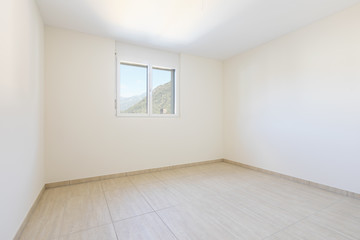 Empty room with white walls and traverti floors