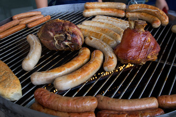 Preparing Meat With sausage in Frying Pan on Barbecue Grill 