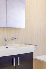 Mobile detail with sink and mirror reflecting lilac of the wall