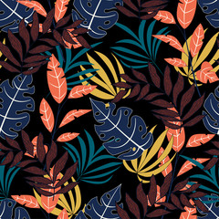 Original seamless tropical pattern with bright colorful leaves and plants on a black background. Tropic leaves in bright colors. Beautiful seamless vector floral pattern. Exotic wallpaper.
