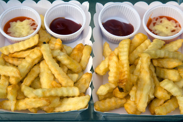 french fries in paper bag and red sauce.
