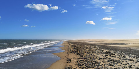 desertic beach with blue sky a waves