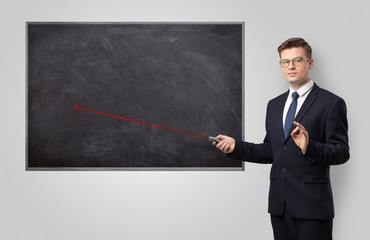 Handsome young teacher with laser pointer teaching