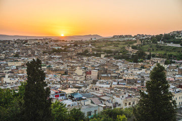 Obraz premium Panoramic scenic view over the roof tops of Medina Fes city at sunrise in Morocco