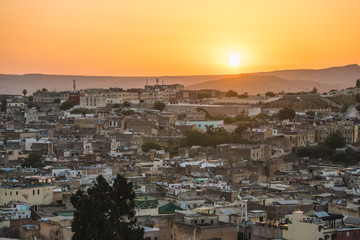 Obraz premium Panoramic scenic view over the roof tops of Medina Fes city at sunrise in Morocco