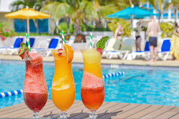 Colorful cocktails with the pool in the background