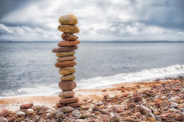 Stone pillar on a shingle beach