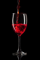 pouring wine glass on black background
