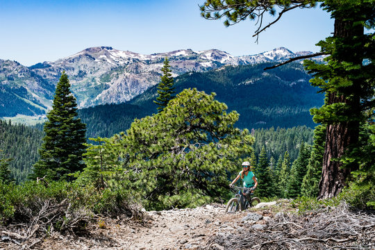 female mountain biker on ridge with scenery