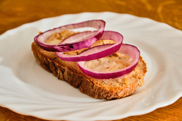 Bread with lard and greaves on white plate