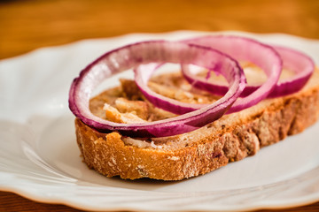 Bread with lard and greaves on white plate