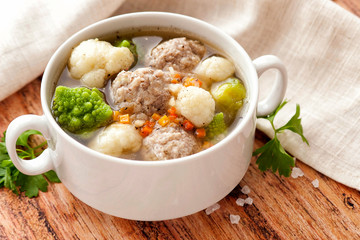 Hot thick soup with meatballs and cabbage mix.
