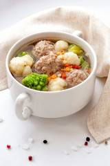 Hot thick soup with meatballs and cabbage mix.