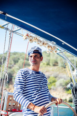 Handsome young man on a sailboat