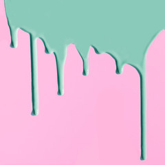 Pouring neo mint paint on pink. Creative abstract pattern with copy space.