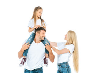 happy mother near husband holding daughter on shoulders isolated on white