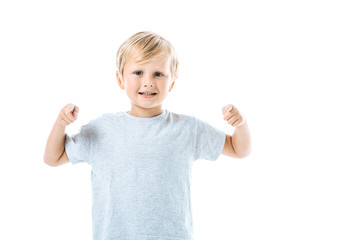 happy boy pointing with fingers while looking at camera isolated on white