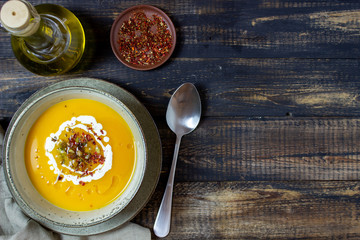 Pumpkin soup on a wooden background. Healthy eating.