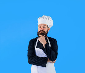 Thinking chef composing new menu. Bearded man in white hat and apron. Male chef, cook or baker in uniform. Man in cook hat and apron thinking what to cook. Cooking, profession and inspiration concept.
