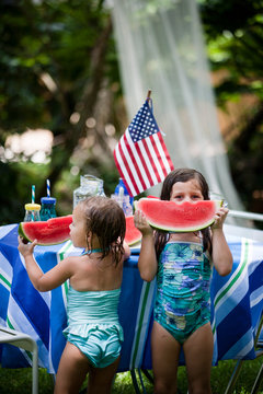 Kids Eating watermelon in their yard on the fourth of July