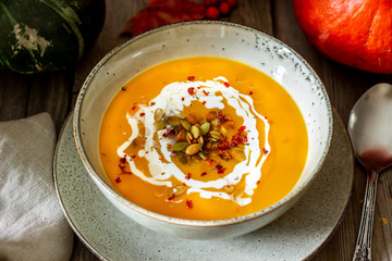 Pumpkin soup on a wooden background. Healthy eating.