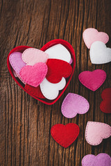 Valentines Day Background. Valentines Day Fabric Hearts Shaped on Wooden Background. Selective focus.