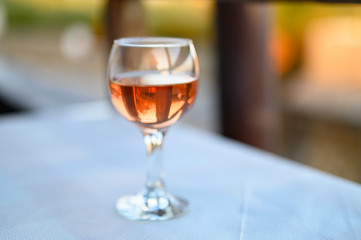 a glass of rose wine on the table in the restaurant