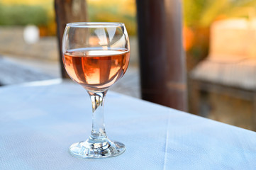 a glass of rose wine on the table in the restaurant