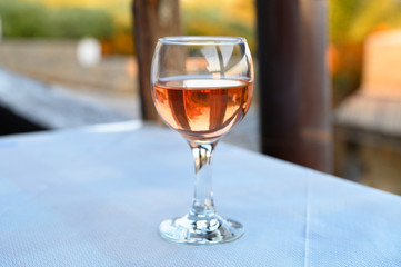 a glass of rose wine on the table in the restaurant
