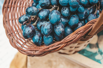 grapes in a basket on wood background