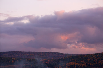 Gray clouds over the autumn forest. Landscape