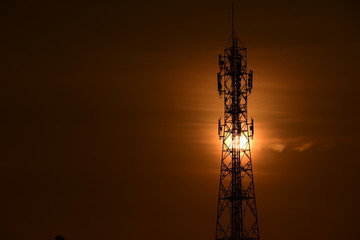 Wireless telephone pole and sunrise orange-yellow sky In the early morning of the day	