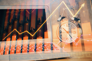 Financial graph colorful drawing and table with computer on background. Double exposure. Concept of...
