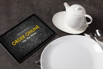 Tablet with online order concept on a lain table