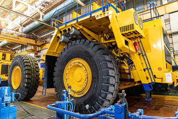 Сonveyor for the production of large yellow trucks, mining trucks. Shop factory. Belaz is a Belarusian manufacturer of haulage and earthmoving equipment, dump trucks, haul trucks, heavy equipm