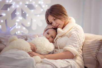 The girl got sick. Mom hugs and kisses a sick daughter