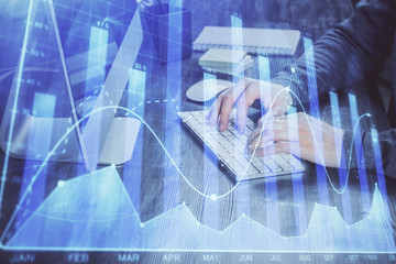 Double exposure of financial graph with man works in office on background. Concept of analysis.