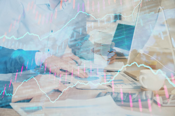 Multi exposure of chart with man typing on computer in office on background. Concept of hard work.