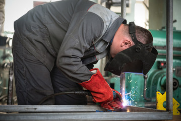 Fototapeta premium Welder is welding a metal frame.