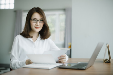 businesswoman working on laptop in her workstation