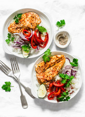 Baked spicy chicken breast with sweet pepper and rice -  delicious mexican style lunch on a light background, top view. Fajitas bowl
