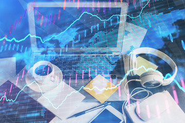 Financial chart drawing and table with computer on background. Double exposure. Concept of international markets.