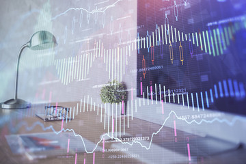 Stock market chart hologram drawn on personal computer background. Double exposure. Concept of...