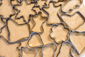 Raw cookies cutted with metal forms before baking. Close up view, selective focus. Confectionery cuisine.