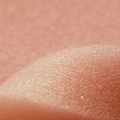 Fototapeta premium White pink artificial foam, soft texture on a light background.