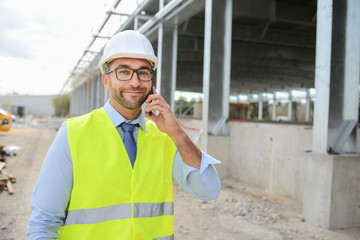 portrait of handsome foreman construction worker on a industrial building industry construction site